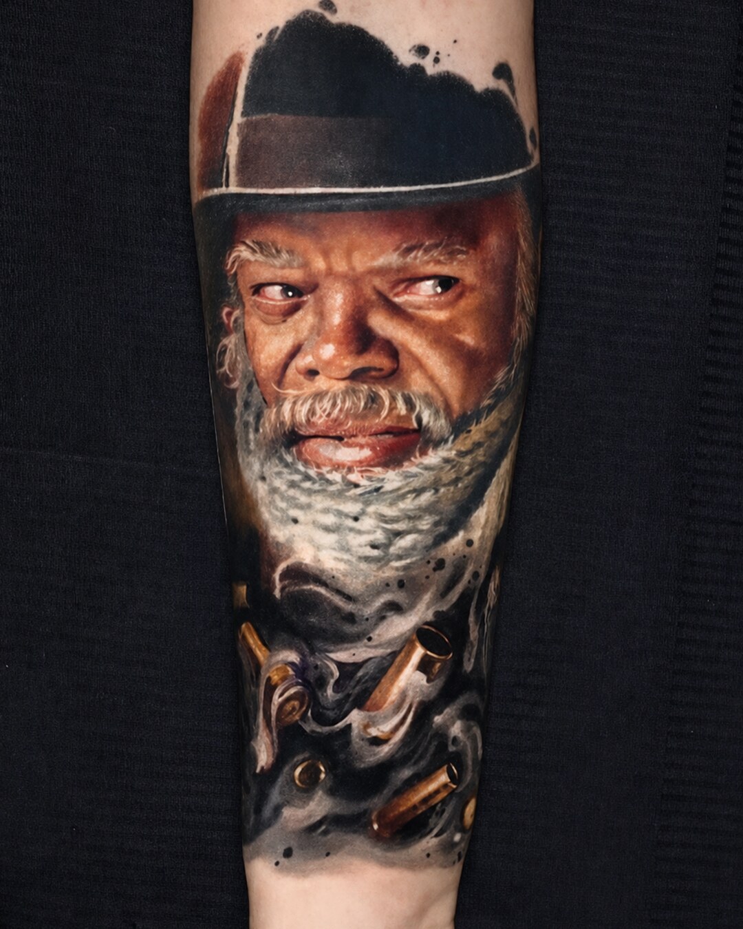 Color realism portrait tattoo of a man in a dark cap