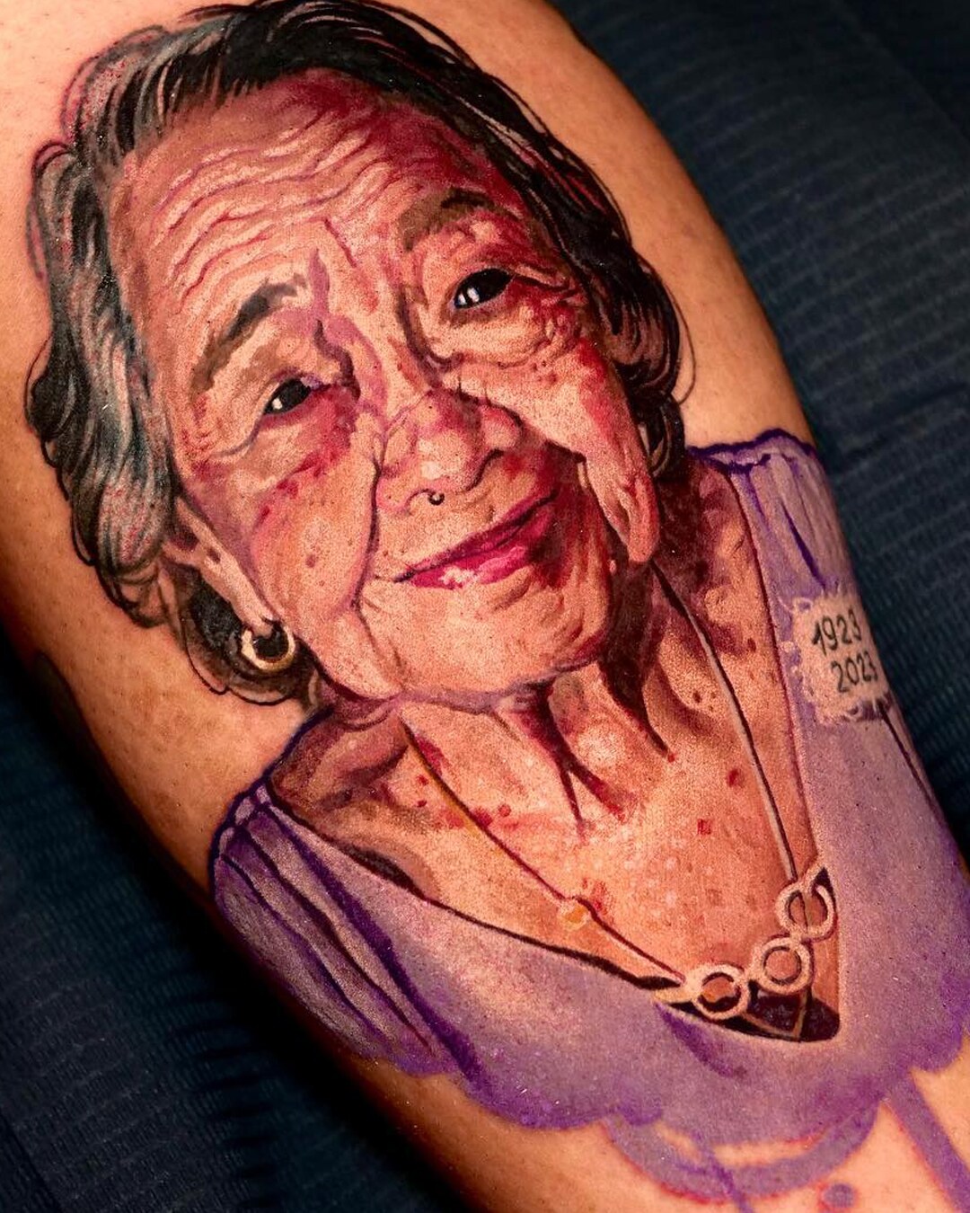 Color realism portrait tattoo of an elderly woman