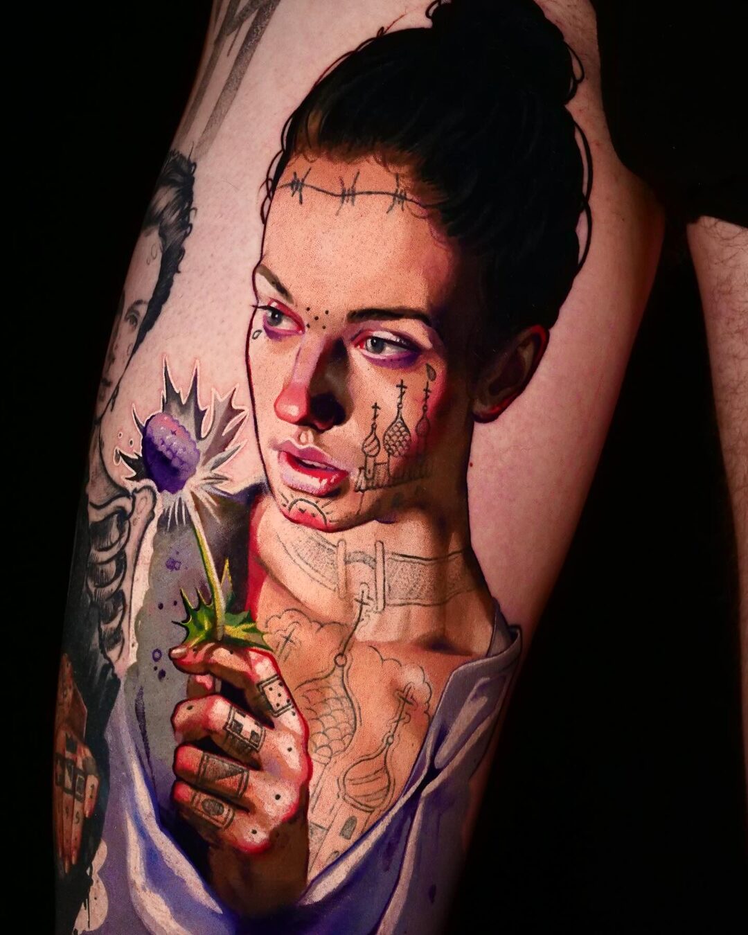 Color realism tattoo of a woman holding a purple flower